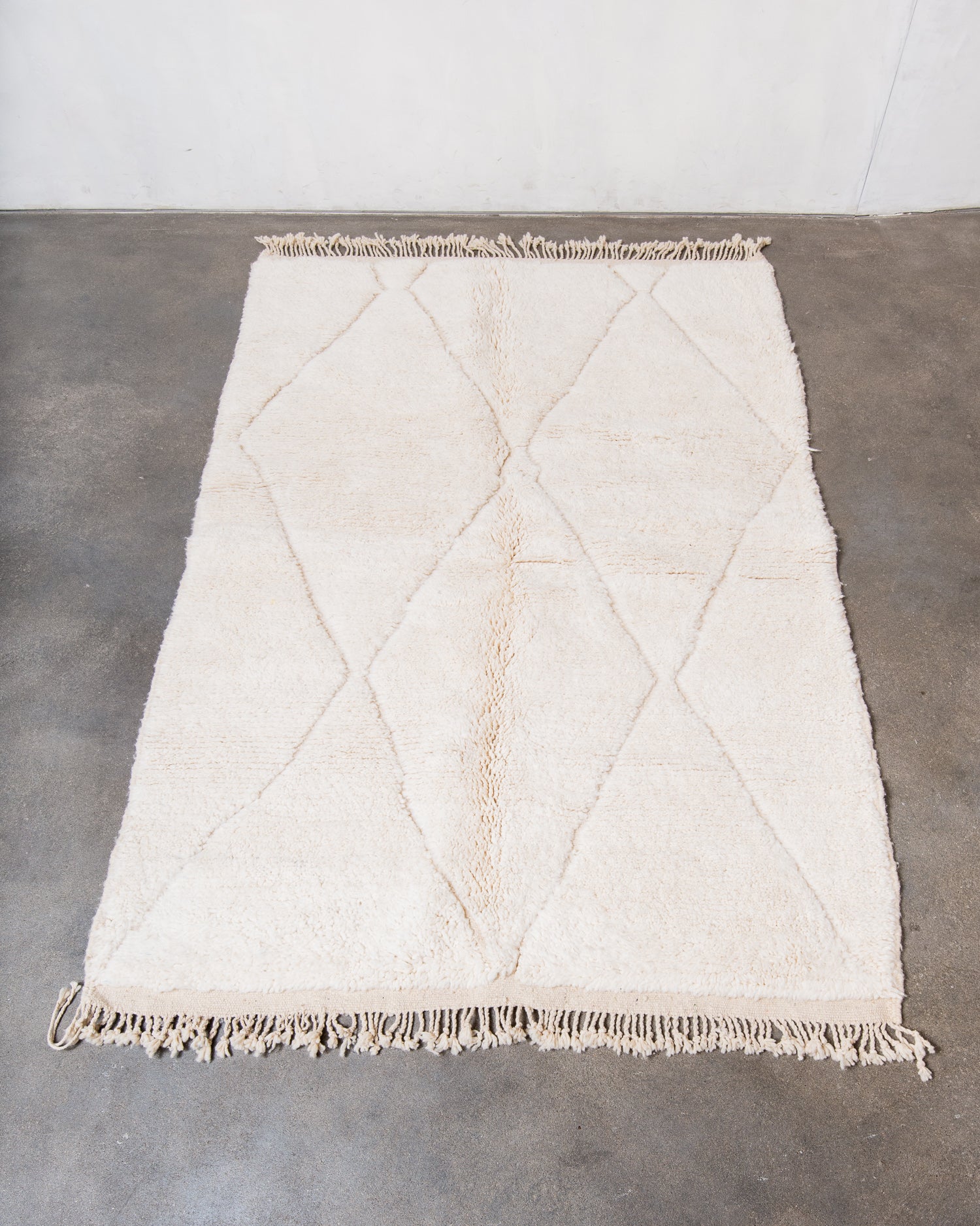 Modern, designer, handcrafted Berber rug from Morocco. Beniourain carpet with minimalist design, natural wool pile and a fluffy texture.